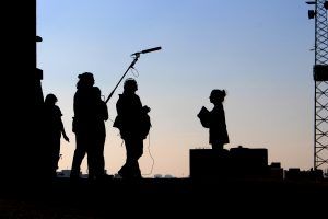 Silhouette of The Creative Catapult film crew on location for a corporate video shoot